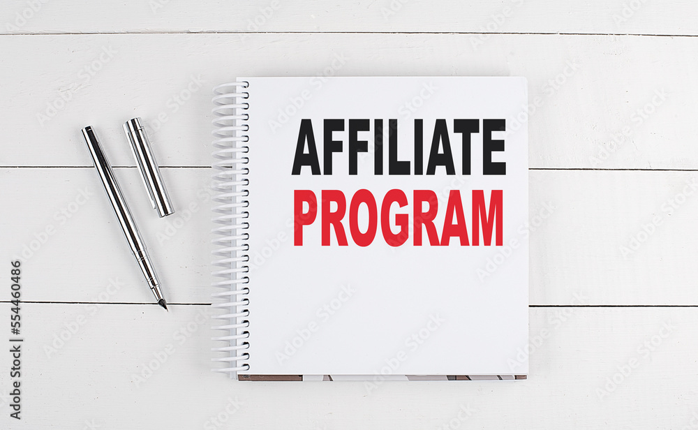 Poster affiliate program text written on notebook on the wooden background