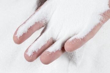 Close-up hand releasing dropping sand. Sand flowing through the hands. Summer beach holiday vacation concept