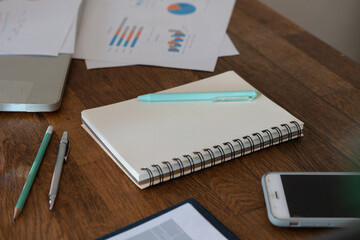 Non people imagery of desk set-up , work environments . work at a desk in a home office. .Writing on a notepad while working from home.