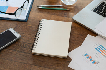 Non people imagery of desk set-up , work environments . work at a desk in a home office. .Writing on a notepad while working from home.