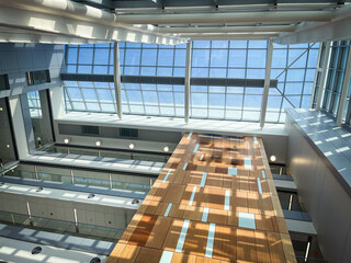 A view towards transparent ceiling of an atrium in modern architecture building