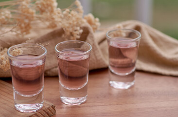 the glass of mocktail on the wooden table