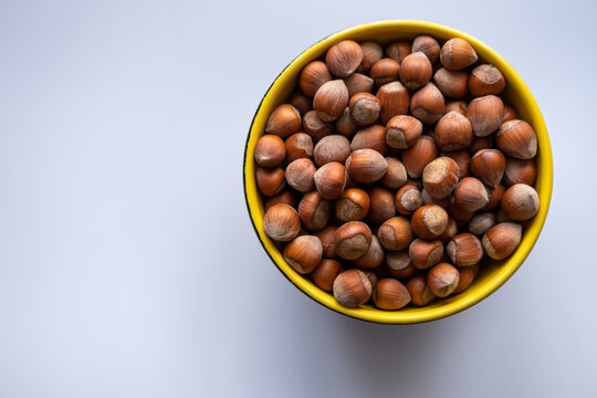 Hazelnut. A bowl of hazelnut. Top view, isolated.
