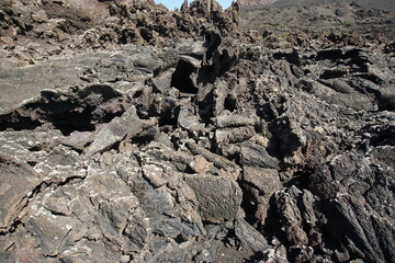 Volcanic landscapes of Lanzarote. Solidified lava, lava chimney, lava tunnel, sea of lava, eruption, canary islands, crater, volcano, black rocks, photographed in November 2022, trekking trip,