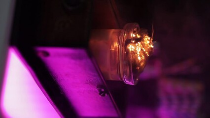 Bartender show  - bartender in a nightclub shows a trick on a bar counter with sparks and fire, close-up, vertical video