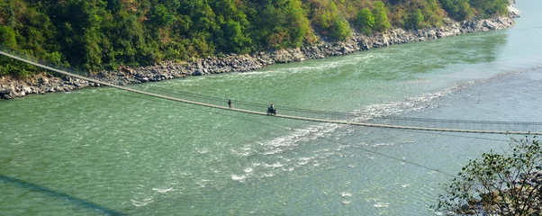 Photo sur Plexiglas Makalu Nepal. Motorbike crossing a suspension bridge. 