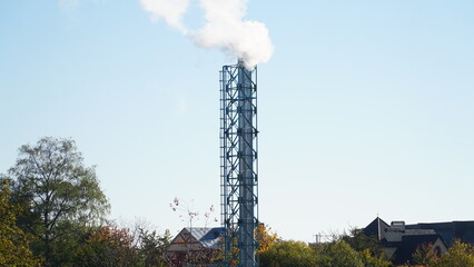 white smoke from the industrial pipe of the boiler room. Heating the house in winter. Heating with wood.