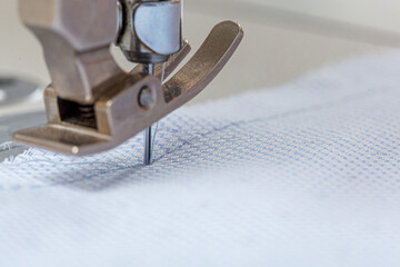 Sewing machine needle with thread and fabric