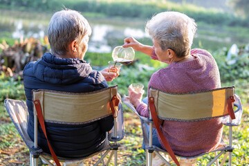 Family aunty mom on holiday travel sit on chair drink morning coffee look green nature relaxation