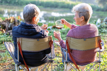 Family aunty mom on holiday travel sit on chair drink morning coffee look green nature relaxation