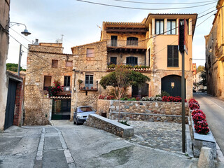 Old stone residential building with balconies on the street of a mediterranean city. Vintage villa for rent for tourists as a hotel or hostel.