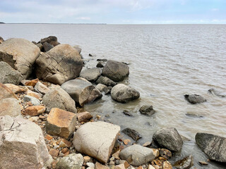 Rocky section of the shore of Lake Khanka in autumn. Russia, Primorsky Krai