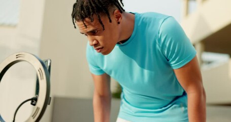 Fitness, black man and phone on tripod for virtual class, live streaming or getting ready to record workout in the city. Active man influencer setting up smartphone camera in preparation for exercise