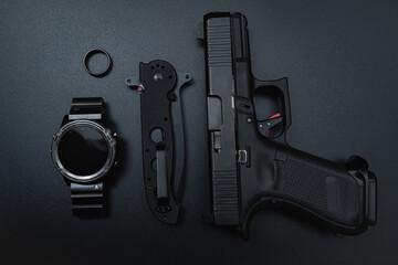 edc for men, gun, smart watch, folding tactical knife, titanium wedding band.