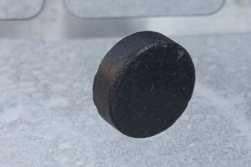 black hockey puck on ice