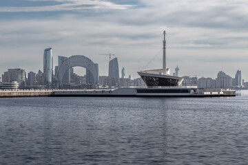 Modern city skyline with skyscrapers on a seafront reflected in water, Baku, Azerbaijan