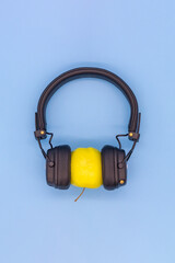 Yellow Apple in headphones listening to music, concept don't be a vegetable, listen to good quality music