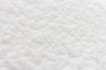 Snow surface, white and clean, with texture. Top view during daytime, frosty day