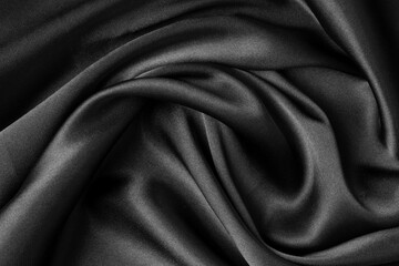 Obraz premium Black fabric texture background, wavy fabric slippery black color, luxury satin cloth texture.