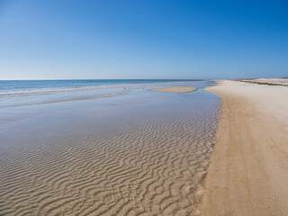 Calm blue sky summer  day on the Gulf of Mexico beach on St George Island in the panhandle or Forgotten Coast area of Florida in the United States