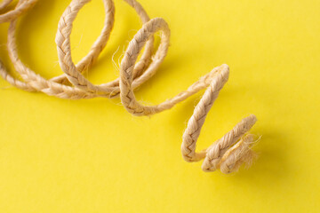 jute decorative ribbon on a yellow background. Decorative element