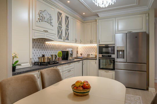Open-concept kitchen with a beige color scheme and classic design elements