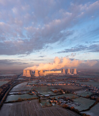 Aerial landscape view of a coal fired Power Station with pollution emissions at sunset