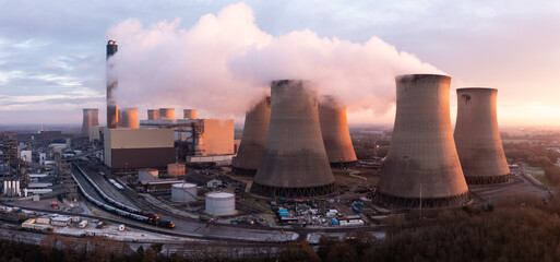 Aerial panorama view of large coal fired Power Station with pollution emissions at sunset