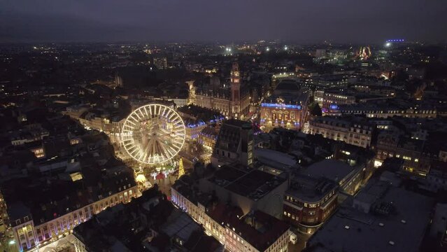 Aerial drone view of Lille, France, at Christmas by night. Amazing 4K video, panoramic view of cityscape