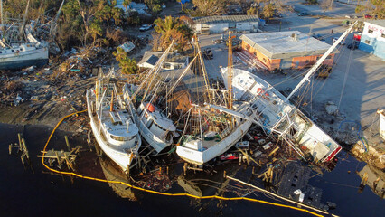 Fishing boats were pushed onto land by the historic storm surge from Hurricane Ian.