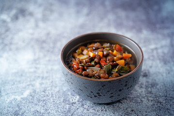 Green Lentil carrots red pepper vegan soup in a bowl