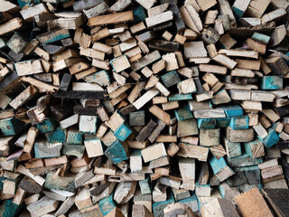 Dry firewood stacked in a pile, chopped wood for winter heating fuel of the fireplace. Natural wood background.