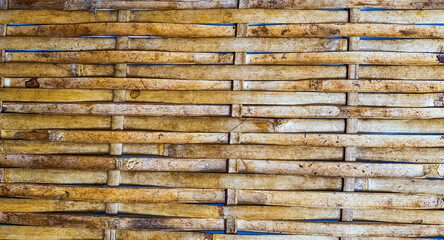 Texture of rattan yellowish bamboo strips background