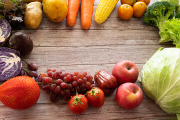 Different freshness vegetables and fruit on wood background.Colorful mixed vegetables for cooking vegetarian food.Diet food.Vegan vegetarian food copy space, banner.Shopping food in fresh supermarket