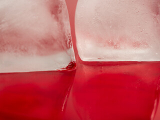 Ice cubes on a red background. Ice on red.