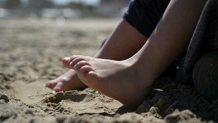 Child foot on sand outside. Closeup kid barefoot feet at beach feeling nature