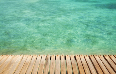 Fototapeta na wymiar Wooden pier boards at a sea, selective focus, copy space.