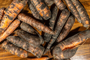 Moldy carrots. Close-up of mouldy vegetables. Wasted food gone bad.