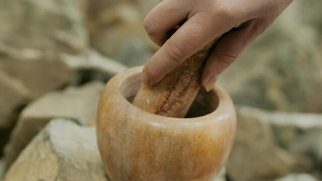 Stone mortar and pestle close-up. Media. Traditional oriental cuisine or medicine, devices for grinding ingredients for food and medicine.