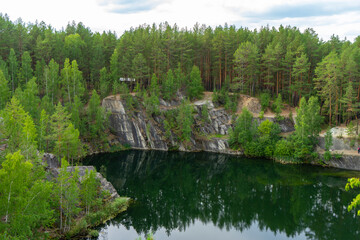 Fototapeta na wymiar Talkov Kamen or Talkov Stone is flooded quarry that formed lake in Sysert district, Sverdlovsk region, Russia. Bazhovskie Places Natural Park. Abandoned talc mine