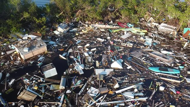 Debris from Hurricane Ian litters the waters of Fish Trap Bay on Bonita Beach, FL
