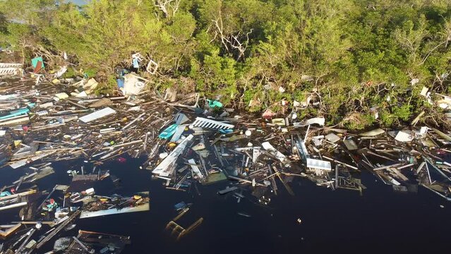 Debris from Hurricane Ian litters the waters of Fish Trap Bay on Bonita Beach, FL