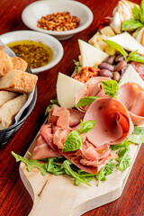 Charcuterie Board. Cheese Board Assortment on cured and salted deli meats and cheeses, pastrami, salami, prosciutto served with olives and dried fruits. Classic traditional party favorite.  