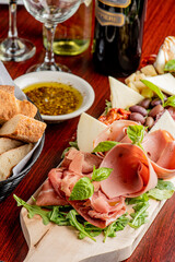 Charcuterie Board. Cheese Board Assortment on cured and salted deli meats and cheeses, pastrami, salami, prosciutto served with olives and dried fruits. Classic traditional party favorite.  