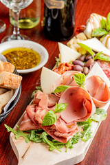 Charcuterie Board. Cheese Board Assortment on cured and salted deli meats and cheeses, pastrami, salami, prosciutto served with olives and dried fruits. Classic traditional party favorite.  