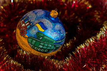 New Year tree decoration with the picture of tractor with blue-yellow Ukrainian flag that pulls a...