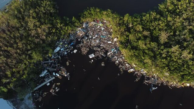 Debris from Hurricane Ian litters the waters of Fish Trap Bay on Bonita Beach, FL