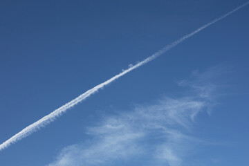 Blue sky with airplane traces. High quality photo.