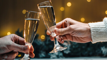 Toast for new year with a glass of Champagne