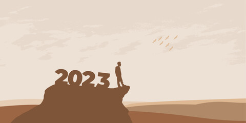 New Year 2023 concept. Man meets dawn in mountains for new year 2023. New Start motivation inspirational quote message on silhouette man